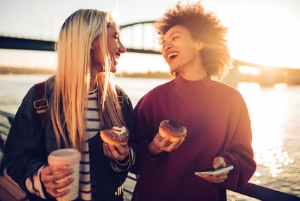 Girls eating donuts and smiling , coffe-donuts
