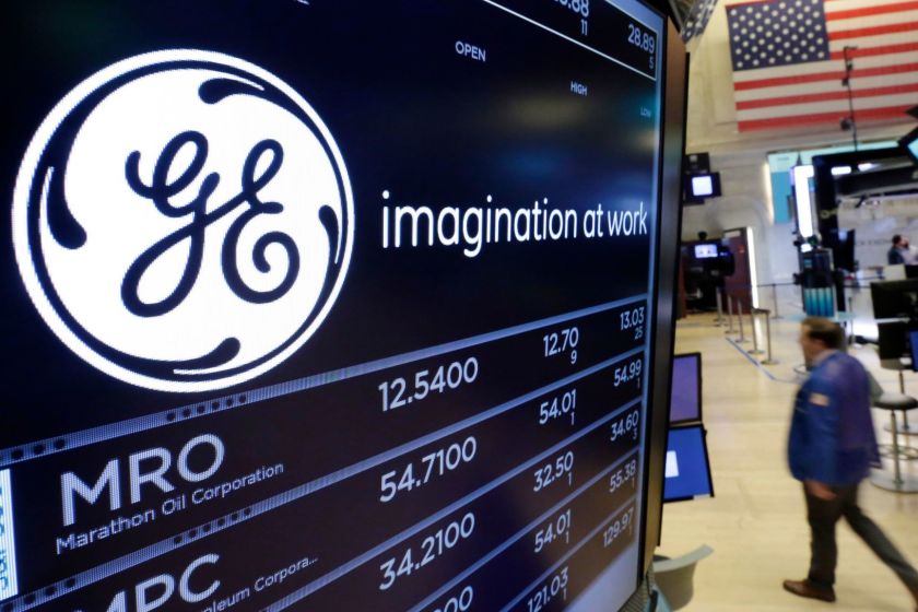 FILE - In this June 12, 2017, file photo, the General Electric logo appears above a trading post on